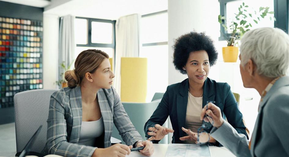 Legal professionals gathered around table conversing