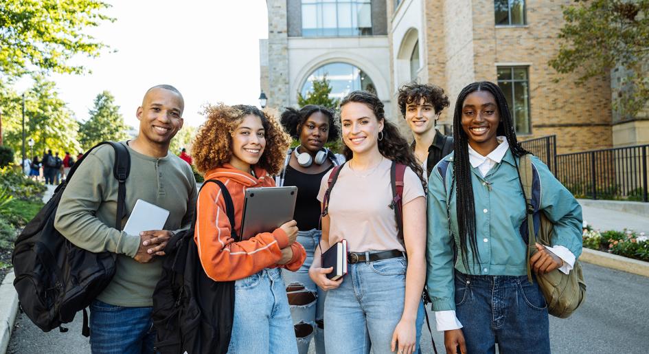 Group of law students gathered outside, smiling at camera