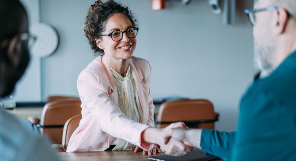 Two legal professionals shaking hands