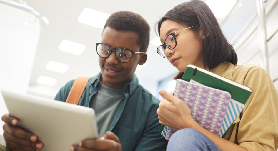 Diverse law students looking at a tablet together