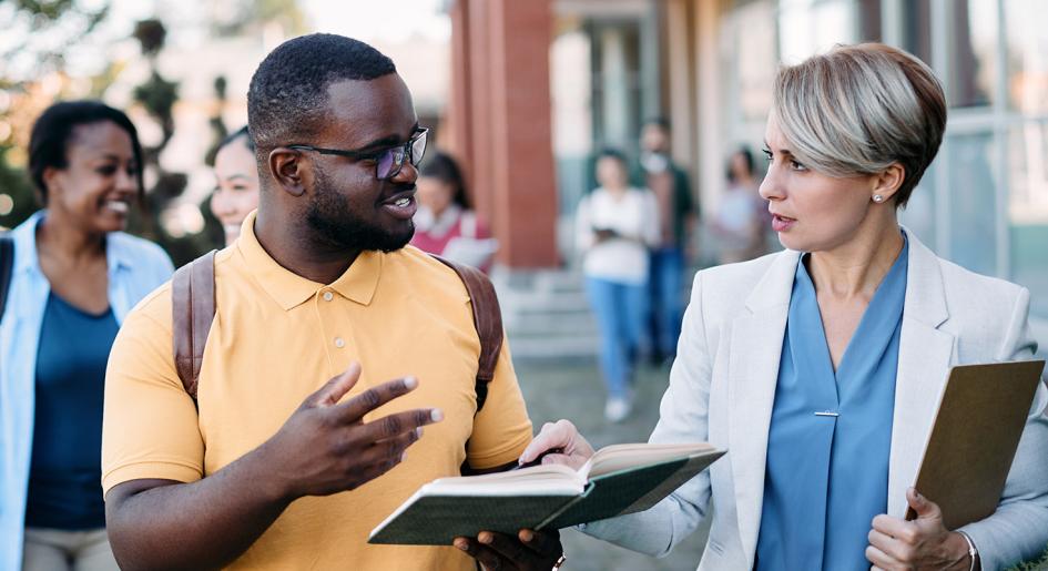 Student speaking with an advisor on campus