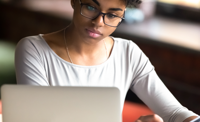 Student with glasses at laptop