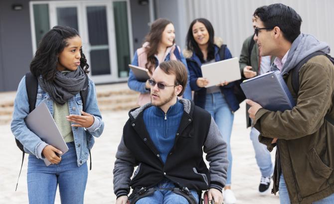 law student who uses a wheelchair talking with peers