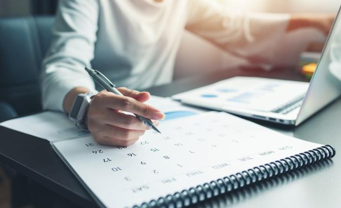 Someone writes on a calendar