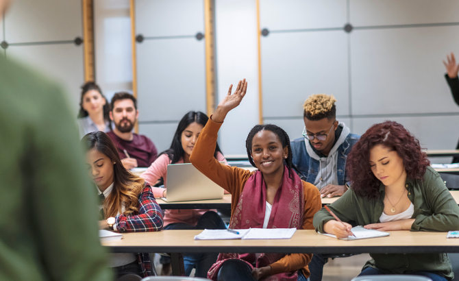 Law students raising hands and participating in class.