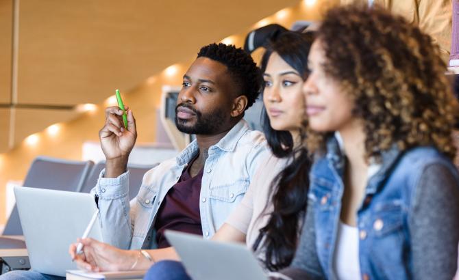 Law students in lecture hall listening.