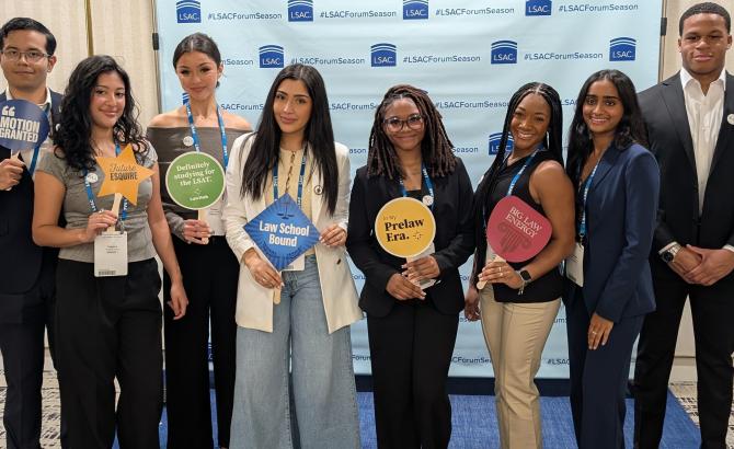 a group of students at a photobooth at the Miami forum