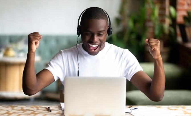 Test taker flexing his arms in front of a laptop