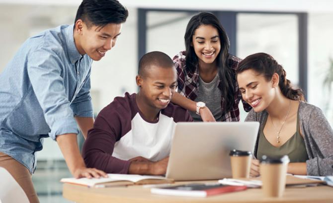 Diverse students gathered around laptop