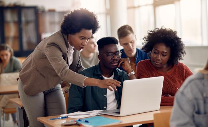 Law students gathered around laptop