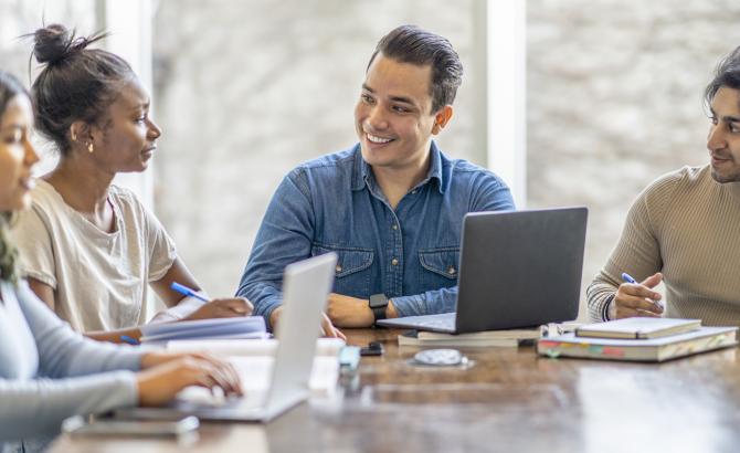 Diverse law students conversing around a table