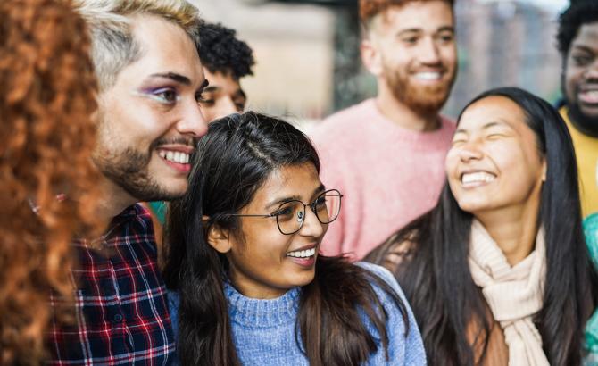 Group of diverse students gathered together smiling