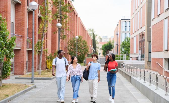 A group of students walk through campus