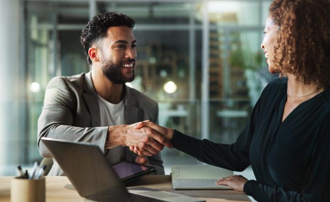 Two people shake hands