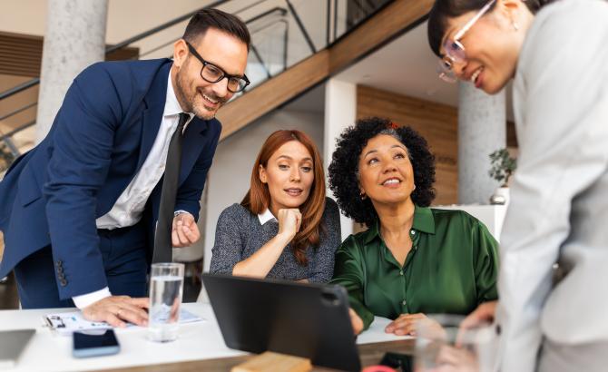 A group of professionals sit around a table
