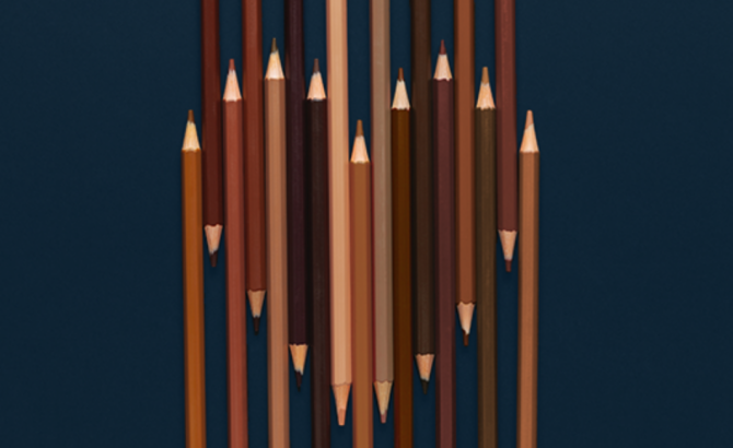 Skin-tone colored pencils form a heart