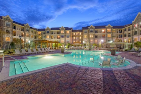 Student housing with pool shown in evening light.